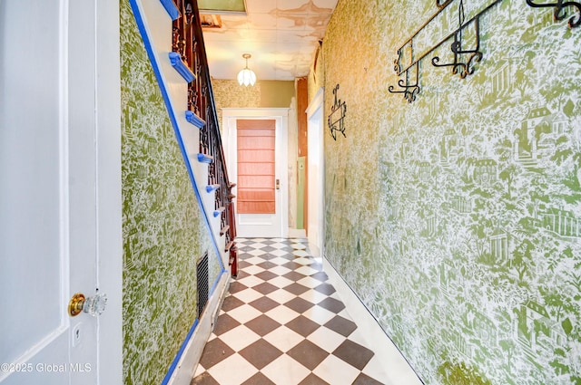 corridor featuring stairs, wallpapered walls, visible vents, and tile patterned floors