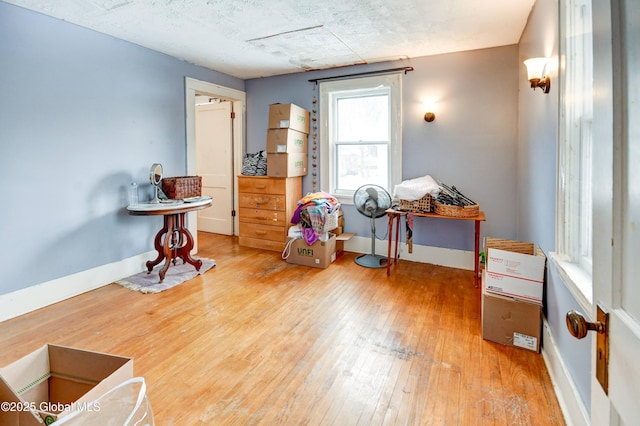 miscellaneous room featuring wood-type flooring and baseboards