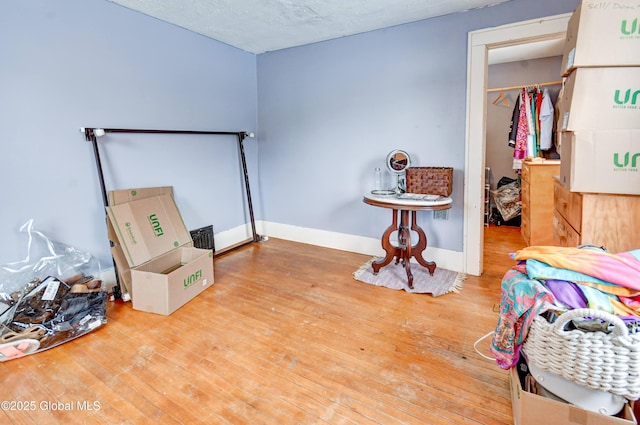 bedroom featuring baseboards and wood finished floors