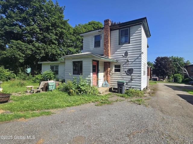 110 Montgomery St, Canajoharie, NY 13317 - view of front facade with a chimney