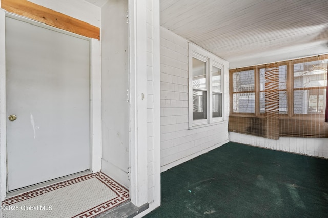 view of exterior entry featuring covered porch