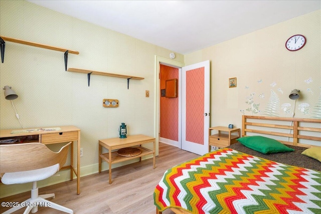 bedroom featuring light wood-type flooring and baseboards