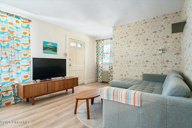 living room with radiator, wood finished floors, and wallpapered walls