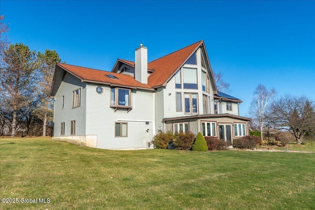 rear view of property with a yard