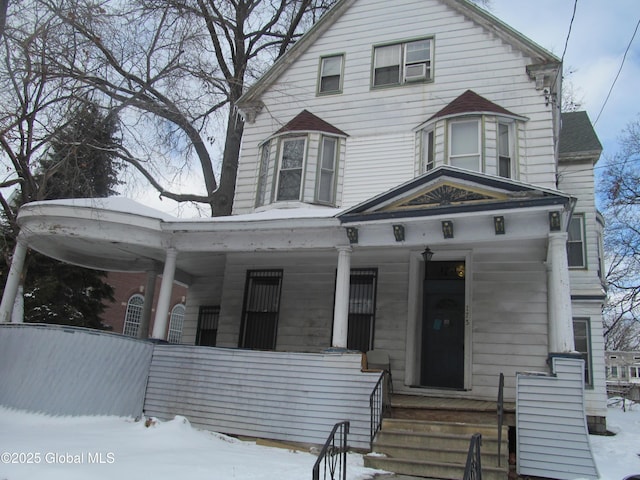 victorian-style house featuring a porch