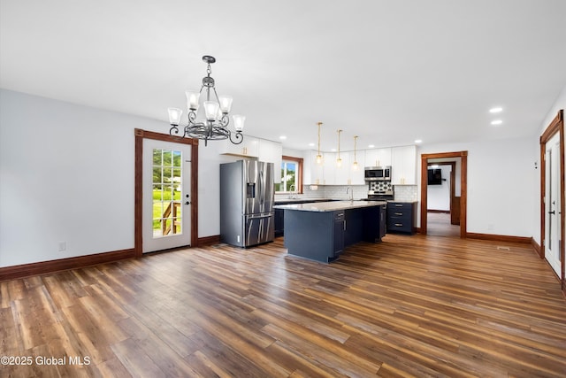11208 State Route 22, Fort Ann, NY 12827 - kitchen featuring appliances with stainless steel finishes, white cabinets, a chandelier, a sink, and baseboards