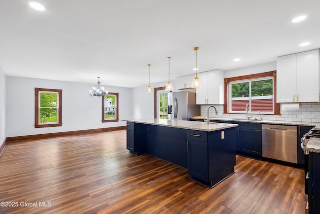 11208 State Route 22, Fort Ann, NY 12827 - kitchen featuring appliances with stainless steel finishes, a kitchen island with sink, dark wood-style flooring, backsplash, and recessed lighting