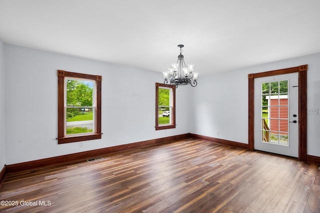 11208 State Route 22, Fort Ann, NY 12827 - empty room featuring a chandelier, wood finished floors, and baseboards