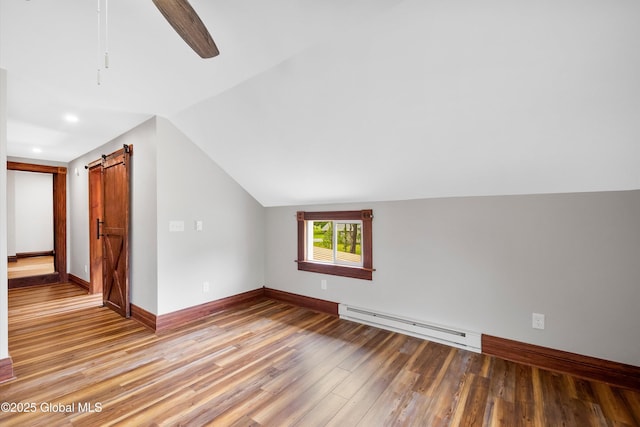 11208 State Route 22, Fort Ann, NY 12827 - additional living space featuring baseboard heating, vaulted ceiling, light wood-style flooring, baseboards, and a barn door