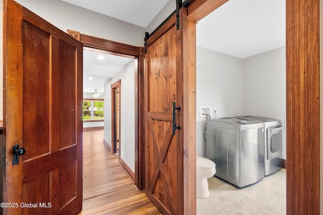 11208 State Route 22, Fort Ann, NY 12827 - laundry area with a barn door, separate washer and dryer, baseboards, light wood finished floors, and recessed lighting
