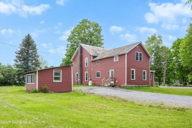 11208 State Route 22, Fort Ann, NY 12827 - view of side of property with a chimney, a yard, gravel driveway, and roof with shingles
