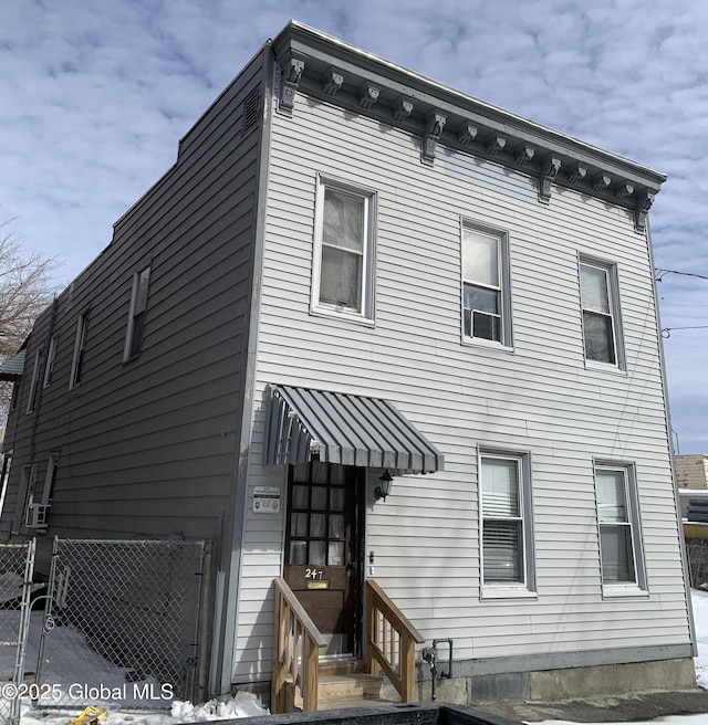 view of front of house featuring fence