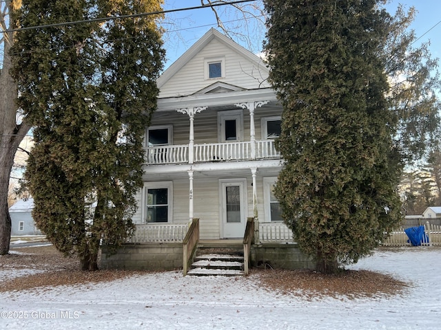 view of front facade featuring a balcony and covered porch