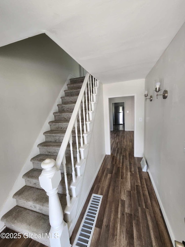 staircase with hardwood / wood-style flooring