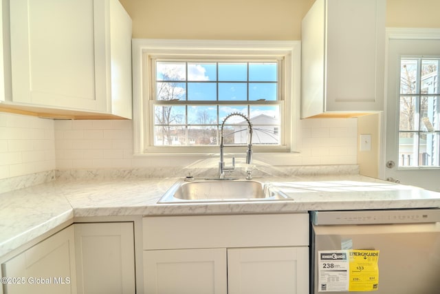 kitchen featuring a sink, stainless steel dishwasher, and white cabinets