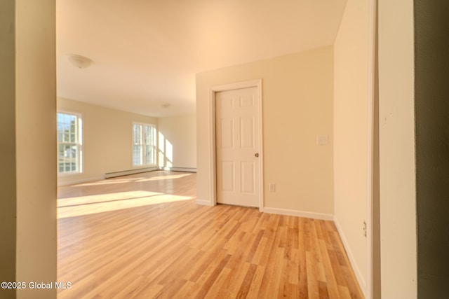 empty room featuring wood finished floors and baseboards