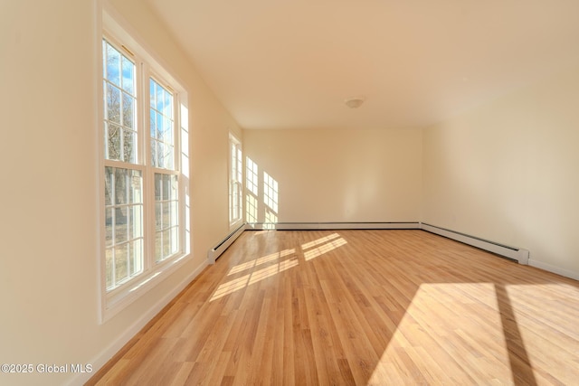 empty room with baseboards and wood finished floors