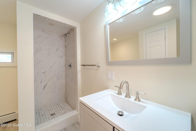 full bath featuring vanity, baseboard heating, and a shower stall