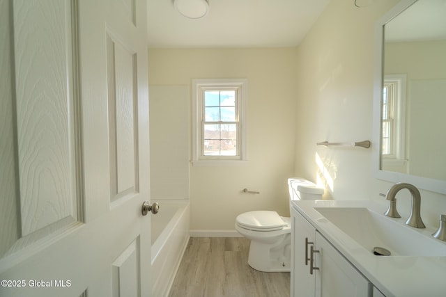 full bath with toilet, vanity, baseboards, and wood finished floors