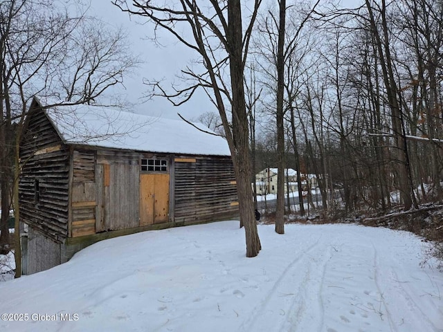 yard covered in snow featuring an outdoor structure