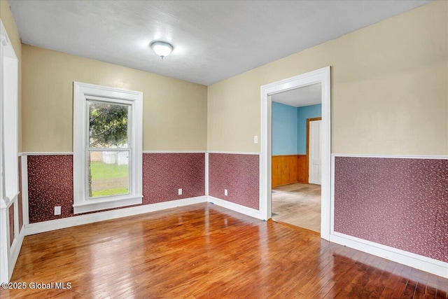 7383 State Highway 28, Exeter, NY 13315 - unfurnished room with baseboards, wainscoting, and hardwood / wood-style floors