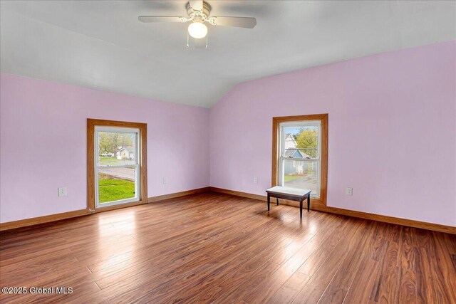 7383 State Highway 28, Exeter, NY 13315 - unfurnished room featuring lofted ceiling, baseboards, plenty of natural light, and wood finished floors