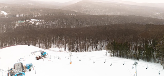 snowy aerial view with a mountain view