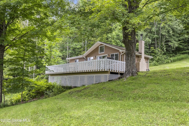 117 Kleis Rd, Fleischmanns, NY 12430 - rear view of house with a deck, a chimney, a lawn, and a view of trees