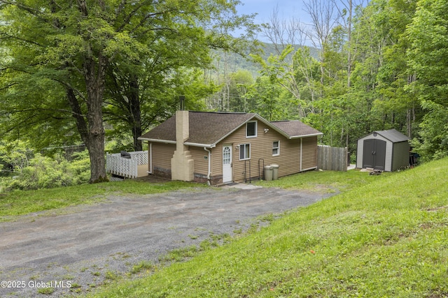 117 Kleis Rd, Fleischmanns, NY 12430 - view of front of property featuring a shed, roof with shingles, and a wooded view