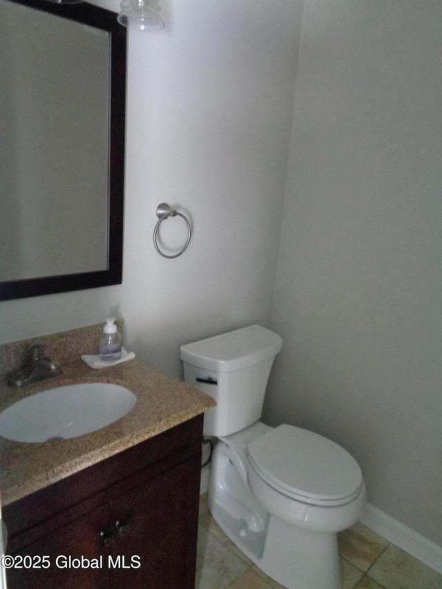 bathroom with vanity, toilet, and tile patterned floors