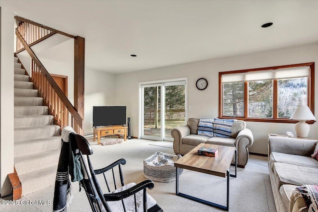 carpeted living room with stairs and baseboards