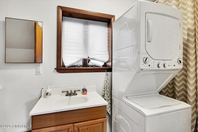 clothes washing area with stacked washer and dryer, laundry area, and a sink