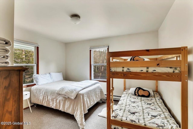 bedroom featuring multiple windows, a baseboard radiator, and carpet flooring