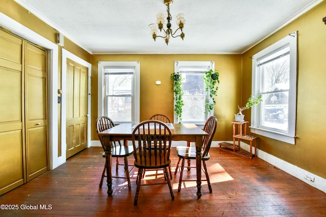 dining area featuring a wealth of natural light, dark wood-type flooring, and an inviting chandelier