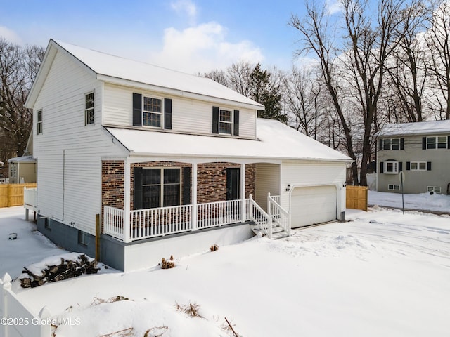 view of front of property with covered porch and a garage