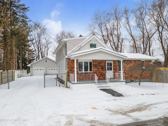 view of front of property featuring fence, an outbuilding, brick siding, and a garage