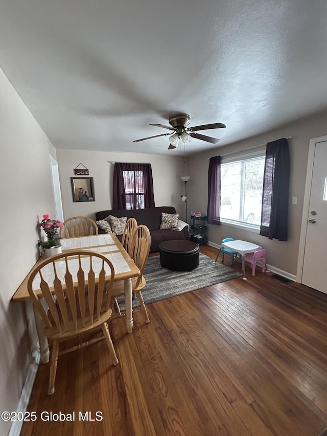 living room with ceiling fan and dark hardwood / wood-style floors