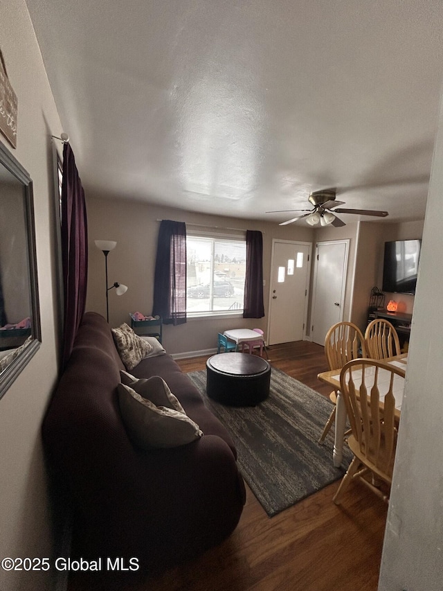 living room featuring ceiling fan and hardwood / wood-style floors