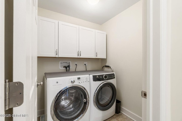 laundry area featuring cabinet space, washing machine and dryer, and baseboards