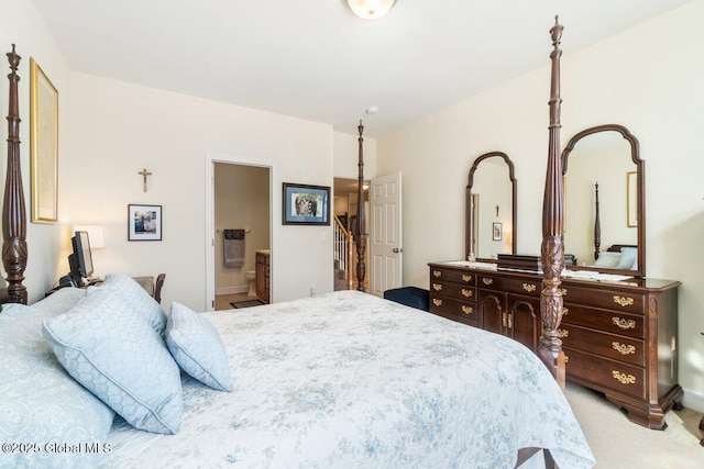 bedroom with light carpet and ensuite bathroom