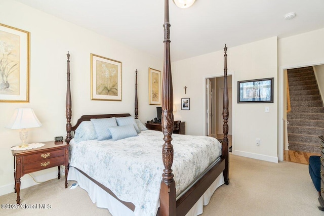 bedroom featuring light carpet and baseboards