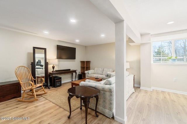 living room featuring light wood finished floors, baseboards, and recessed lighting