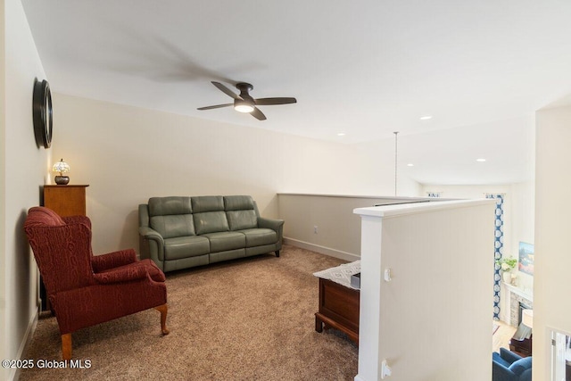 living area featuring carpet flooring and baseboards