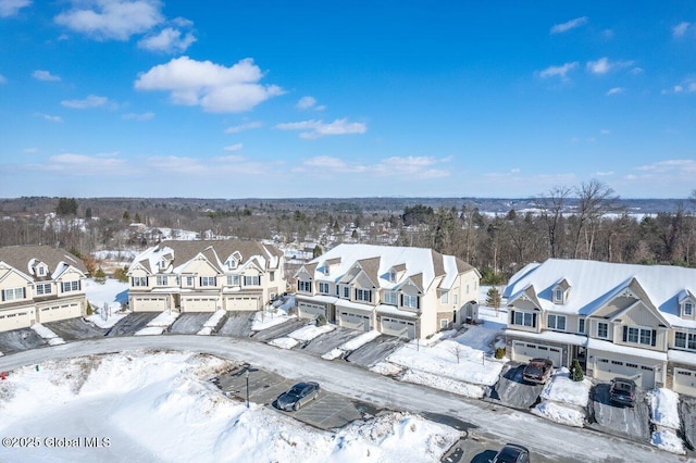 snowy aerial view featuring a residential view