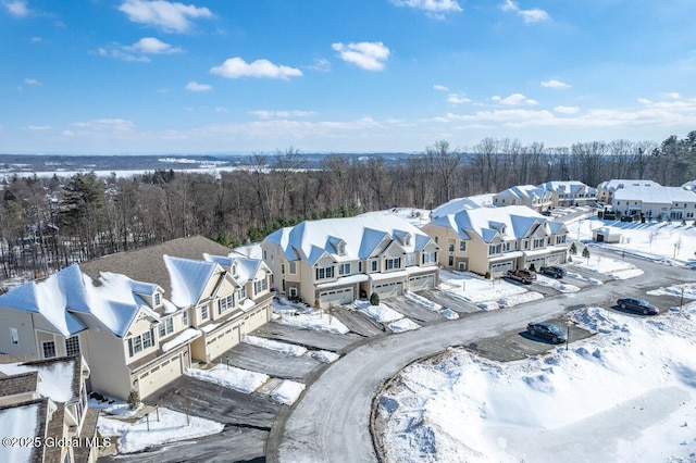 snowy aerial view featuring a residential view