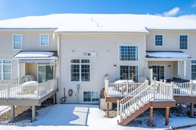 snow covered property with a deck