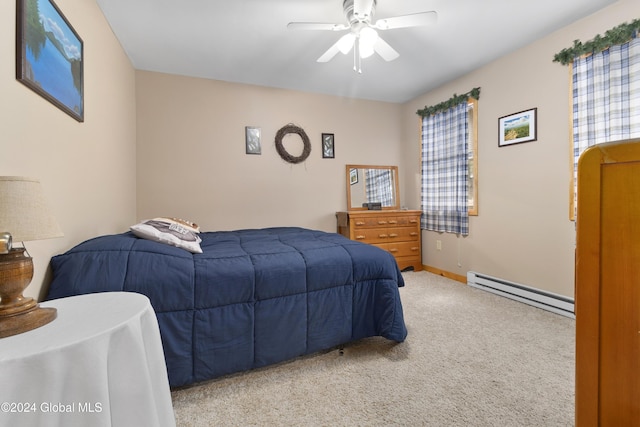 carpeted bedroom with a baseboard heating unit and ceiling fan