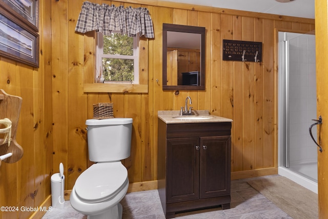 bathroom with wooden walls, vanity, and a shower with door