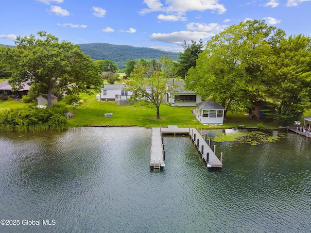 exterior space with a water and mountain view