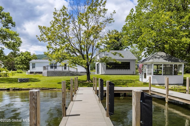 dock area featuring a lawn and a water view